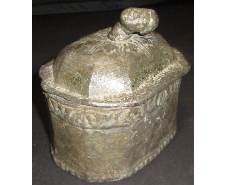 An 18th Century lead tobacco jar, the finial as a blackamoor head, the body of elongated octagonal form, 11.5 cm high