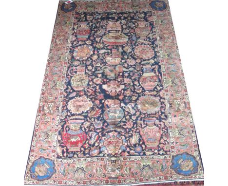 ANTIQUE TABRIZ ZIRKHAKI CARPET, 290cm x 198cm, of polychrome vases and antiquities on sapphire field within corresponding dec