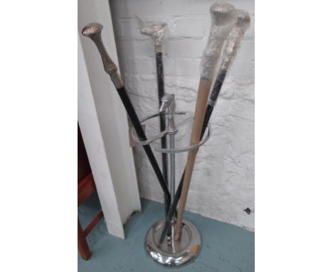 STICK STAND, in plated metal with dogs head finial plus four canes, 101cm H. (5)