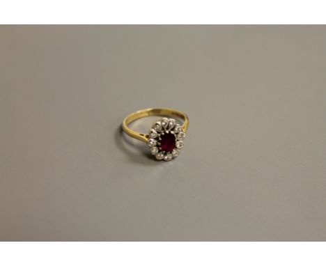 An 18ct gold ruby and diamond cluster ring, size N-O, 4.1g.