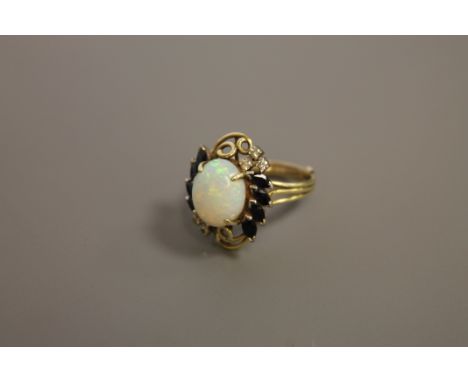 A sapphire and diamond ring set with a large opal 