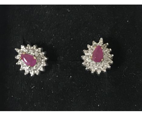 A pair of 9ct gold ruby and diamond cluster earrings.