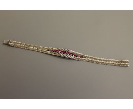 A fine quality ruby and diamond bracelet in 18ct white gold, 52g.