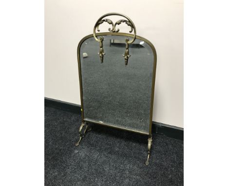 An early 20th century brass mirrored fire screen