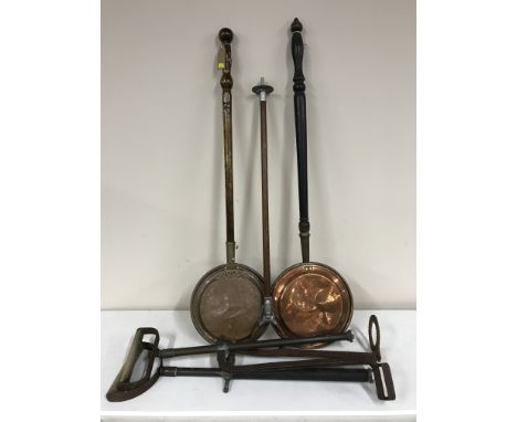 Two copper bed warming pans, shooting stick and two stirrup pumps 