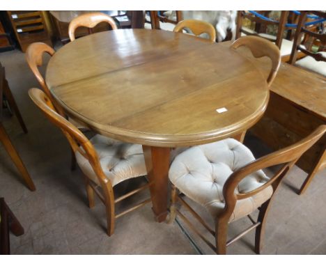 An Edwardian Solid Oak Wind Out Oval Dining Table, on tapered legs and casters, approx 135 x 100 x 75 cms, together with six 