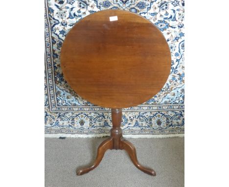 An Antique Mahogany Tilt Top Circular Occasional Table, having turned column support on hoof leg feet, approx 60 x 70 cms.