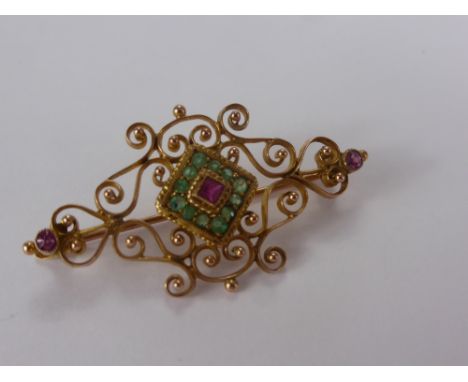 A 9 ct Yellow Gold, Emerald and Ruby Filigree and Bead Brooch, 2 x 2 mm rubies, 1 x 2.25 ruby, 12 x 1.25 emerald on 9 ct pin,