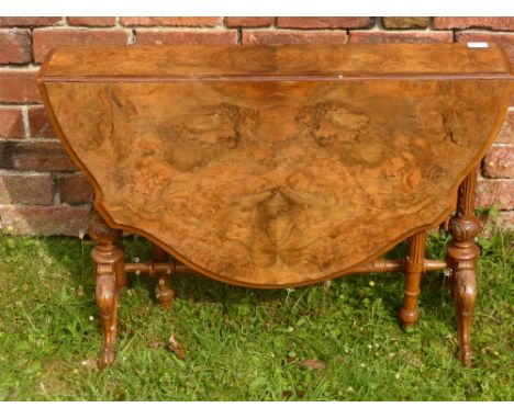 A 19th Century Walnut Veneer Drop Leaf Table, on ornately carved legs and stretchers, approx 109 x 90 cms.