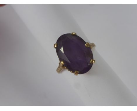 A Lady's 9 ct Gold and Amethyst 18 x 12 mm Dress Ring, size P, wt 5 gms, together with a base metal brooch.