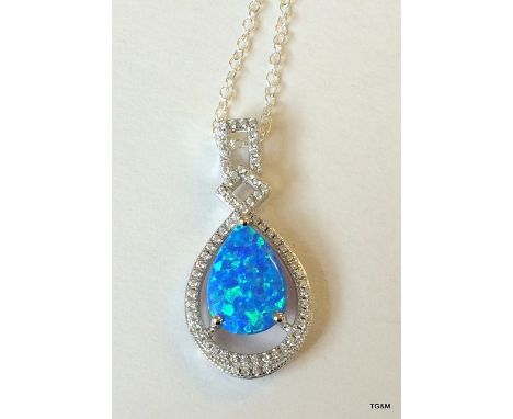 A silver cz and blue opal drop pendant necklace on silver chain