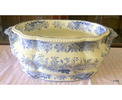 A blue and white foot spa or planter