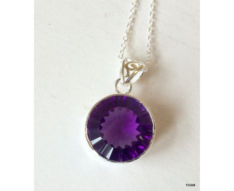 A silver and amethyst pendant necklace on silver chain