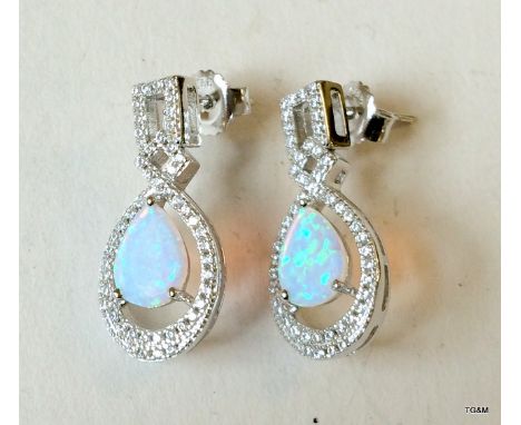 A pair of silver cz and opal drop earrings