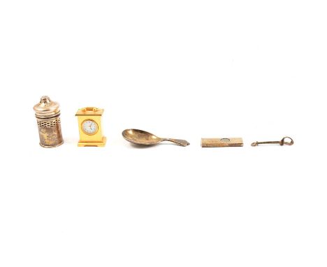 A silver cigar cutter, William Manton, Birmingham 1979; a silver caddy spoon; silver pepper pot with blue glass liner; a silv