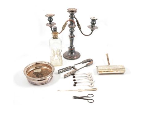 Silver plated three-light candelabra, wine coaster, crumb brush, asparagus servers, a glass bodied decanter with plated mount