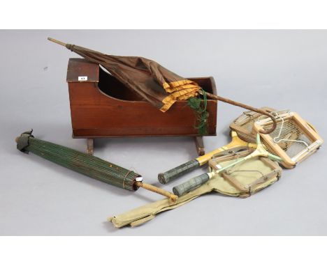 A vintage pine doll’s cradle, 54cm wide; together with three wooden tennis racket, each with press; a parasol; &amp; a ladies