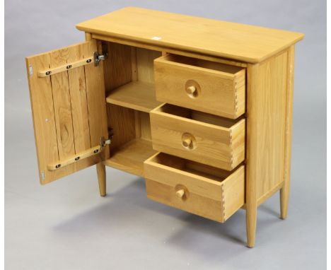 A light oak small side cabinet fitted three long drawers to the right-hand side with cupboard to the left-hand side enclosed 