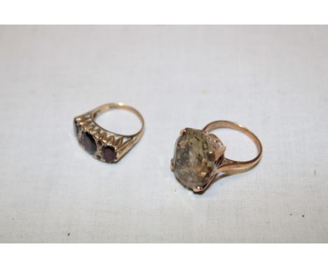 A 9ct gold dress ring set smoky quartz and one other 9ct gold dress ring set garnets (11.9g) (2)