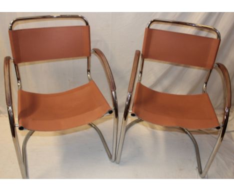A pair of vintage chromium-plated open arm chairs upholstered in leather
