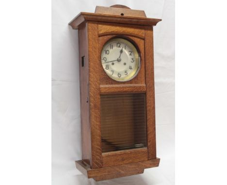 A good quality 1920/30s wall clock with silvered circular dial in polished oak glazed case