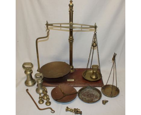 A brass shop scales by Young Son & Marlow of Westminster with brass pans, selection of brass weights and various accessories
