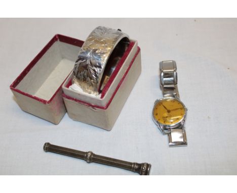 A silver oval bangle with engraved floral decoration, propelling pencil and a gent's wristwatch (3)