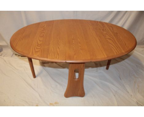 An Ercol pale elm oval drop-leaf coffee table