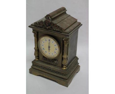 An old ornate brass clock case with raised figure and columns, 8" high containing a modern movement