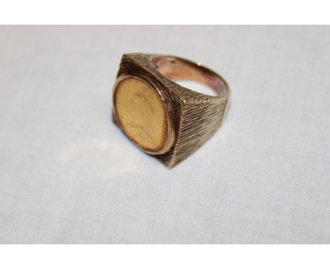 A heavy 9ct gold signet ring inset with a Victorian gold sovereign (33.2g gross)