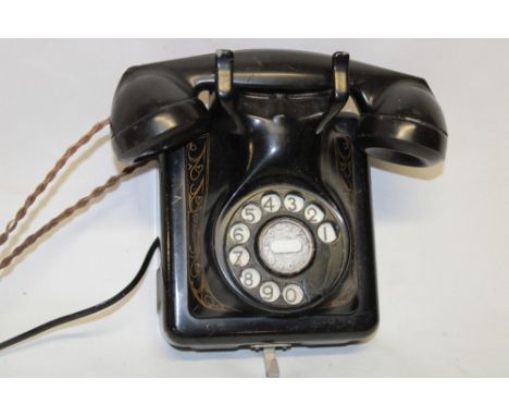 A vintage wall mounted telephone by the Bell Telephone Manufacturing Company