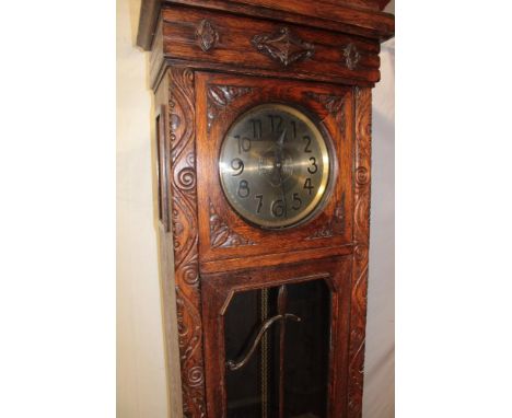 A 1930's/40's oak long case clock with silvered dial in carved oak rectangular case