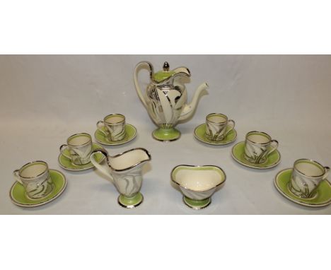 A Susie Cooper china coffee set with silver and green decoration comprising a tapered pedestal coffee pot, matching cream jug