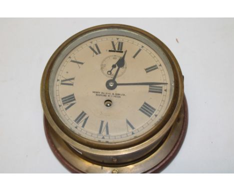 A ship's bulk head style clock by Henry Browne and Son Limited, Barking, London with circular dial and brass cylindrical case