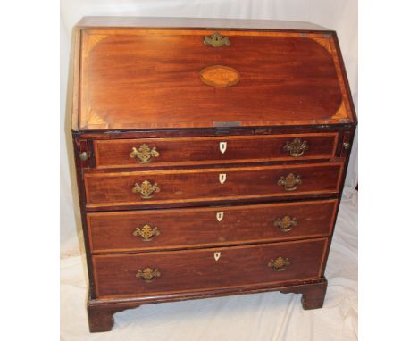 A 19th century inlaid mahogany bureau with pigeon holes and drawers enclosed by a fall front above four long graduated drawer