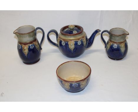 A Royal Doulton pottery four-piece tea set with green and blue glazed decoration comprising a circular tea pot, water jug, mi