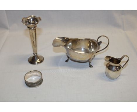 A silver classical shaped sauce boat with scroll handle and hoof feet, Birmingham marks; small silver tapered cream jug; silv