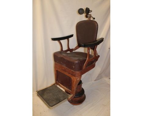 An unusual 1920's/30's barber's/dentist chair having a metal frame with simulated wood-effect combing, leather seat and back 