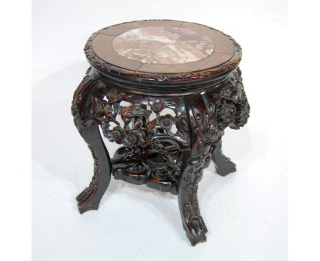 CHINESE CARVED PADOUK AND PINK VEINED MARBLE LOW JARDINIERE STAND, the moulded circular inset top above a foliate carved frie
