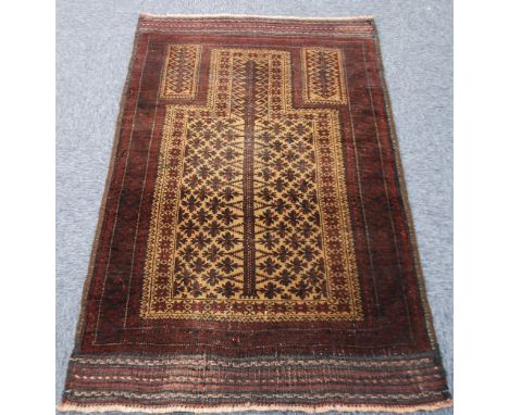 EASTERN PRAYER RUG, with rectangular panel and mihrab filled with flower heads and latch hooks in black and brown on a light 