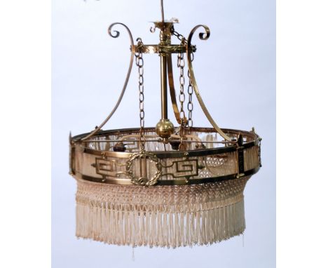 EARLY TWENTIETH CENTURY PIERCED BRASS THREE LIGHT ELECTROLIER, the cream silk and tasseled shade with wreath and Greek key cu