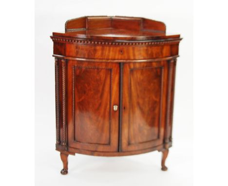 NINETEENTH CENTURY CONTINENTAL FLAME CUT MAHOGANY BOW FRONTED FLOOR STANDING CORNER CUPBOARD, the shaped top with bead edge m