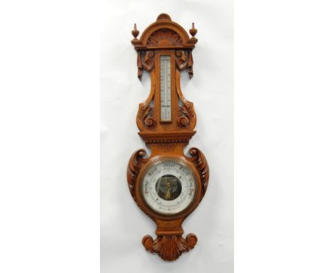 A GOOD EDWARDIAN CARVED OAK CASED ANEROID BAROMETER WITH THERMOMETER, 37" (34cm) high