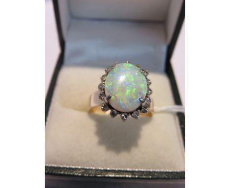 OPAL CLUSTER RING, 18ct gold ring set an oval opal within a cluster of diamonds, size M