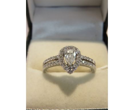 FINE DIAMOND RING, 18ct white gold ring set a pear drop diamond, approx 1ct within a cluster of diamonds, with further diamon