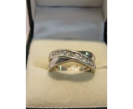 DIAMOND RING, 9ct white gold cross over band ring set 10 diamonds, totalling approx 0.25ct, size K