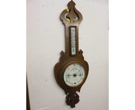 ANEROID BAROMETER, Arts & Craft fretwork oak framed surround aneroid barometer, 30" high