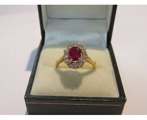 RUBY & DIAMOND RING, 18ct yellow gold ring set an oval ruby surrounded by cluster of diamonds, size O