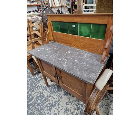 A marble topped tile back washstand.