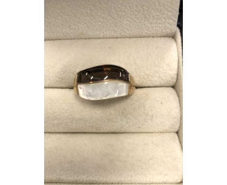 A 9ct hallmarked gold contemporary ring, possibly set with smokey quartz and mother of pear. Ring size P. Weight 3.2 grams. 